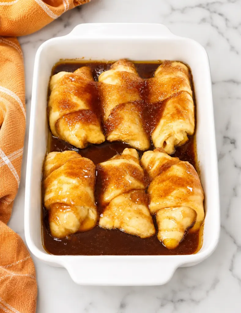 Peach Dumplings with Crescent Rolls baked in cinnamon syrup